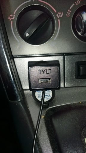 A Tylt-equipped car with a usb charger plugged into it.