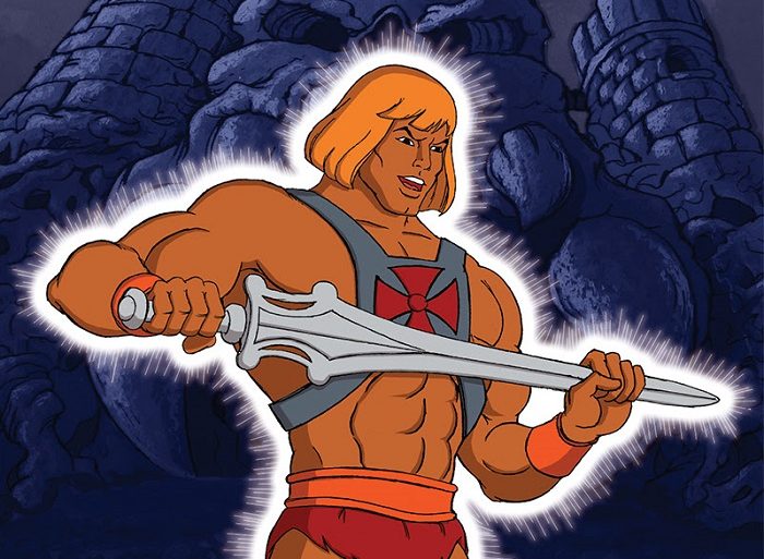 He-Man standing with a sword in front of a castle.