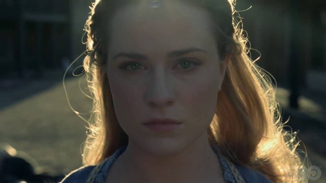 A woman with long blonde hair is staring at the sun. (No relevant keywords found)