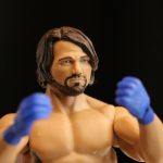 A Mattel toy figure of a boxer with blue gloves.