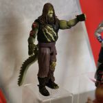 A Mattel WWE action figure with a crocodile.