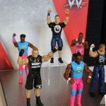 Mattel WWE action figures on display at a convention.