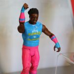 A Mattel toy figure of a wrestler in pink and blue.