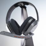 A gaming headset on an ASTRO stand with a microphone.