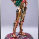 A statue of a man holding a gun, resembling Samus.