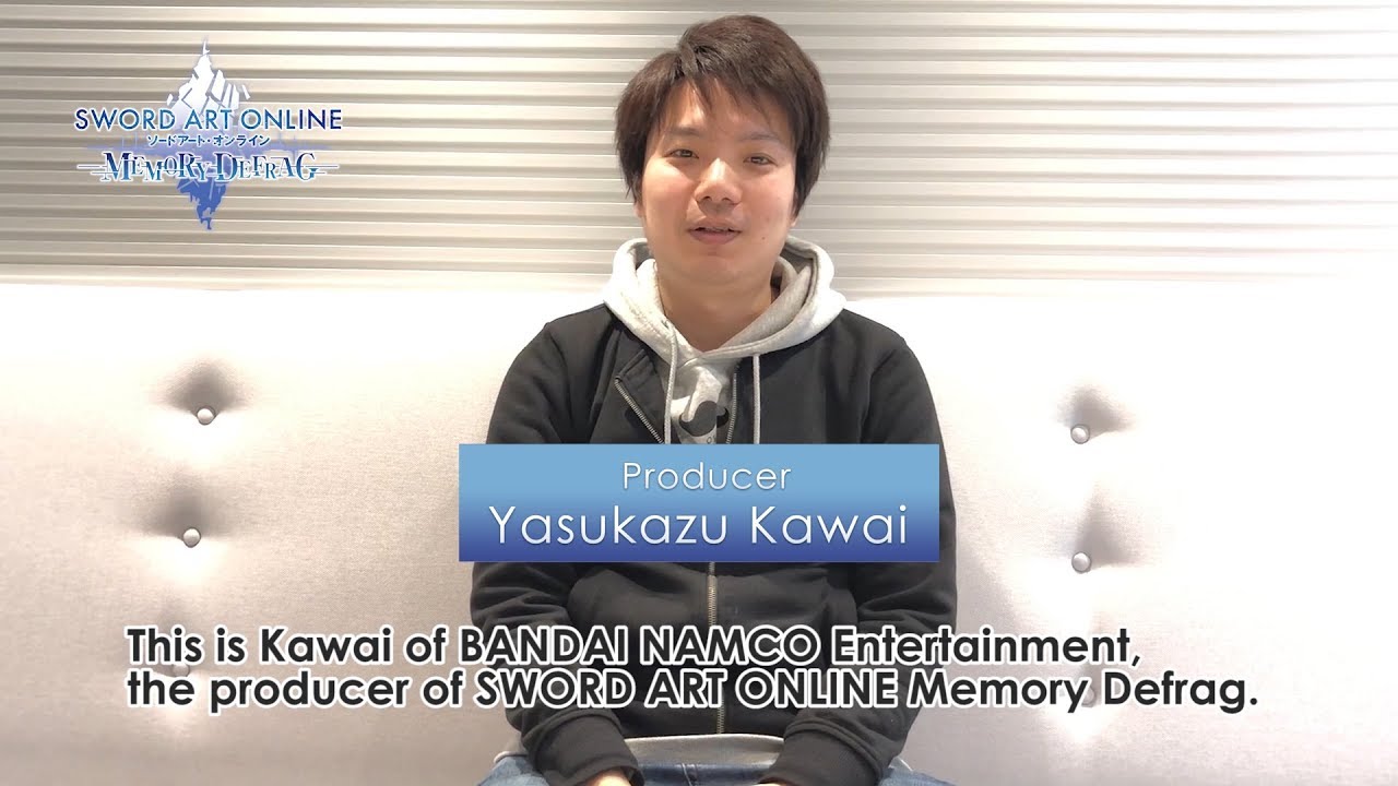 A young man is sitting on a couch, engrossed in the Remake of Secret of Mana.