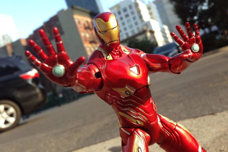 A red Iron Man MK 50 action figure on a street.