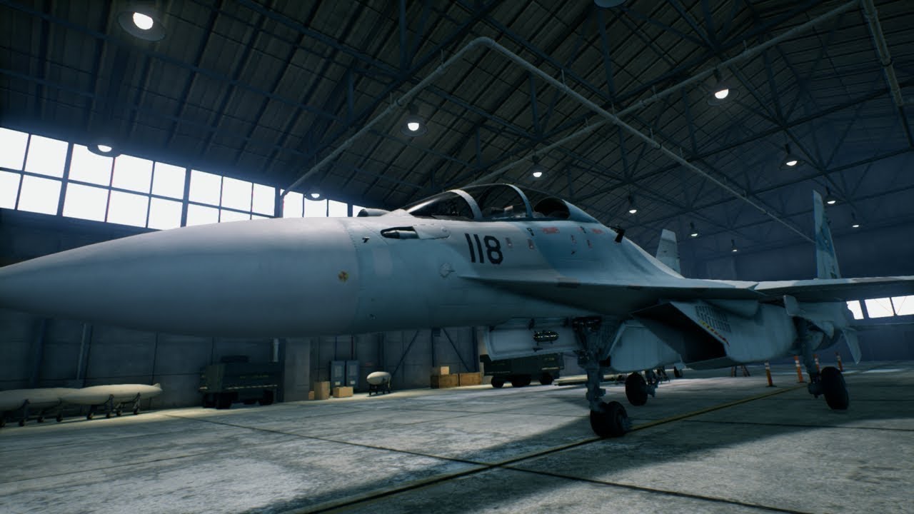 The Ace Combat 7 fighter jet is parked in a hangar, part of the Aces at War Bundle, known for its thrilling battles in the Skies Unknown.