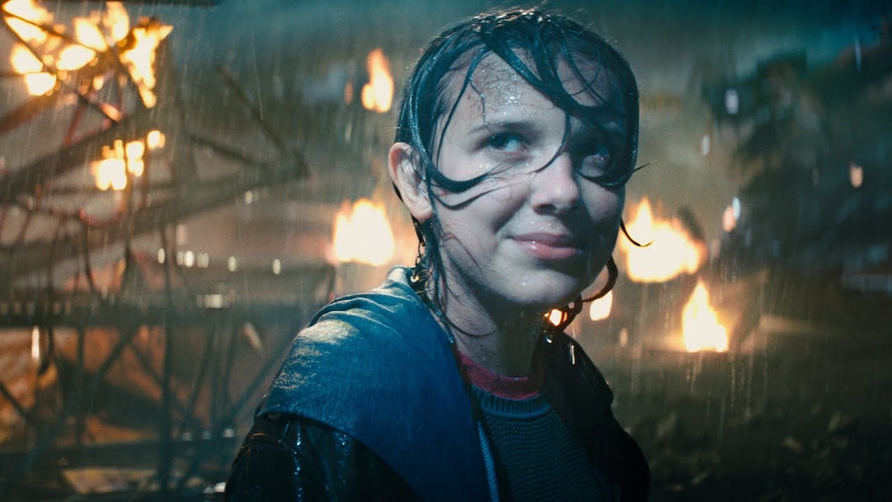 Final Trailer: A boy in a raincoat is standing in front of a fire, giving an intense preview of Godzilla, King of The Monsters.