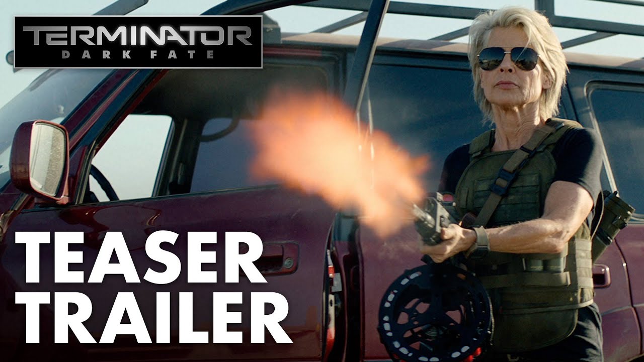 The Terminator: Dark Fate teaser trailer features a woman in a suit holding a gun in front of a car.