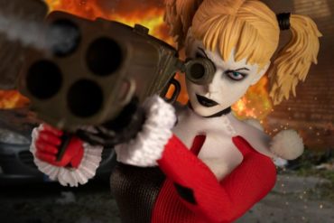 The 12 Collective presents the debut of Jester Suit Harley, an action figure featuring Harley Quinn with a gun.