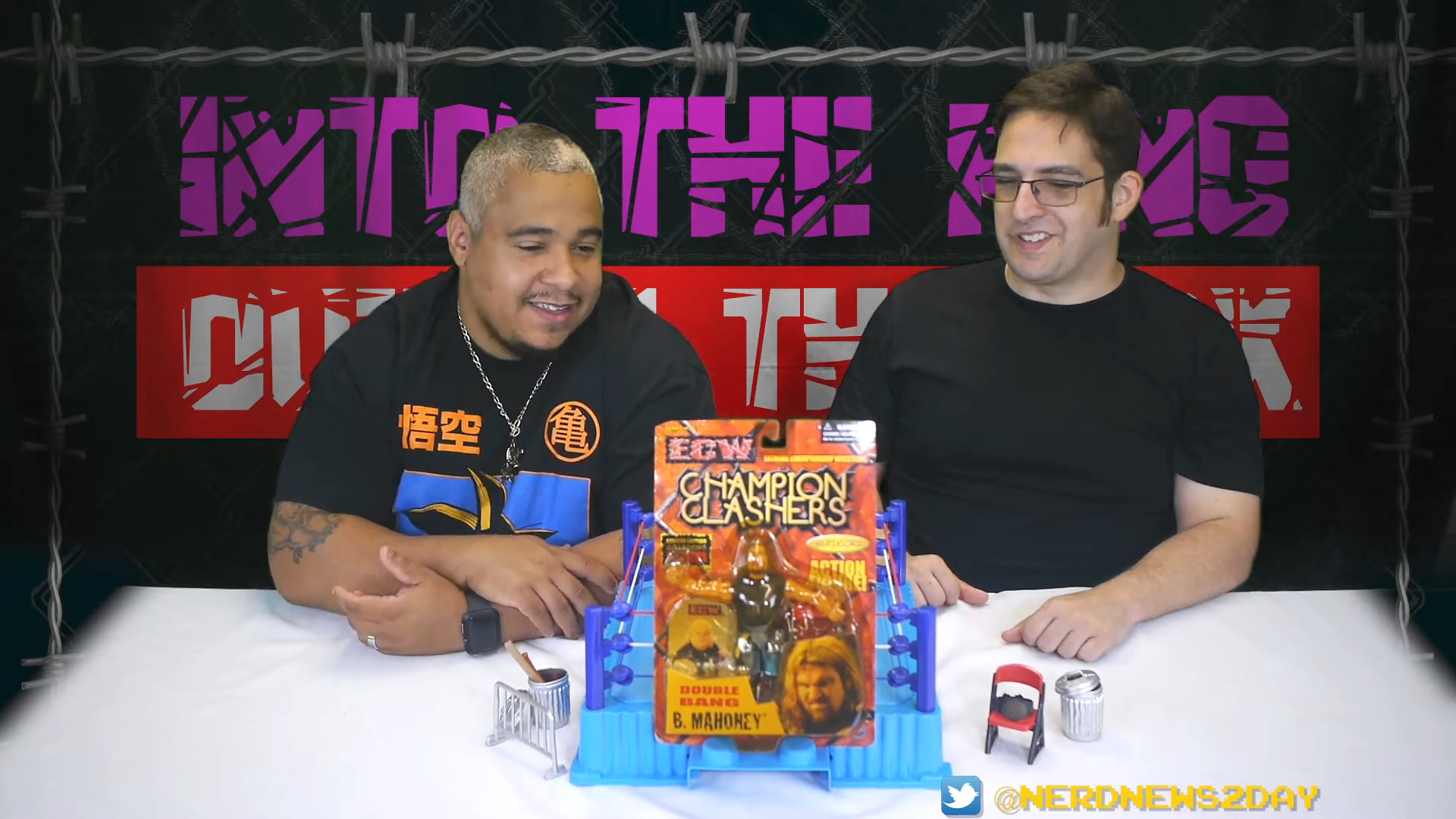 Two men, including ECW Balls Mahoney, sitting in front of a table with a retro review box in front of them.