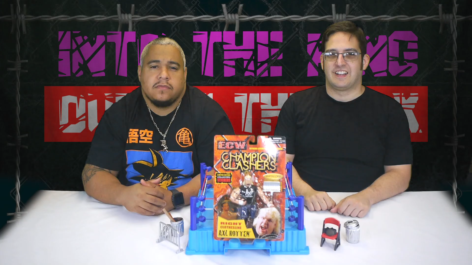 Two men are sitting in front of a barbed wire fence, reminiscent of a Retro Review moment from ECW.