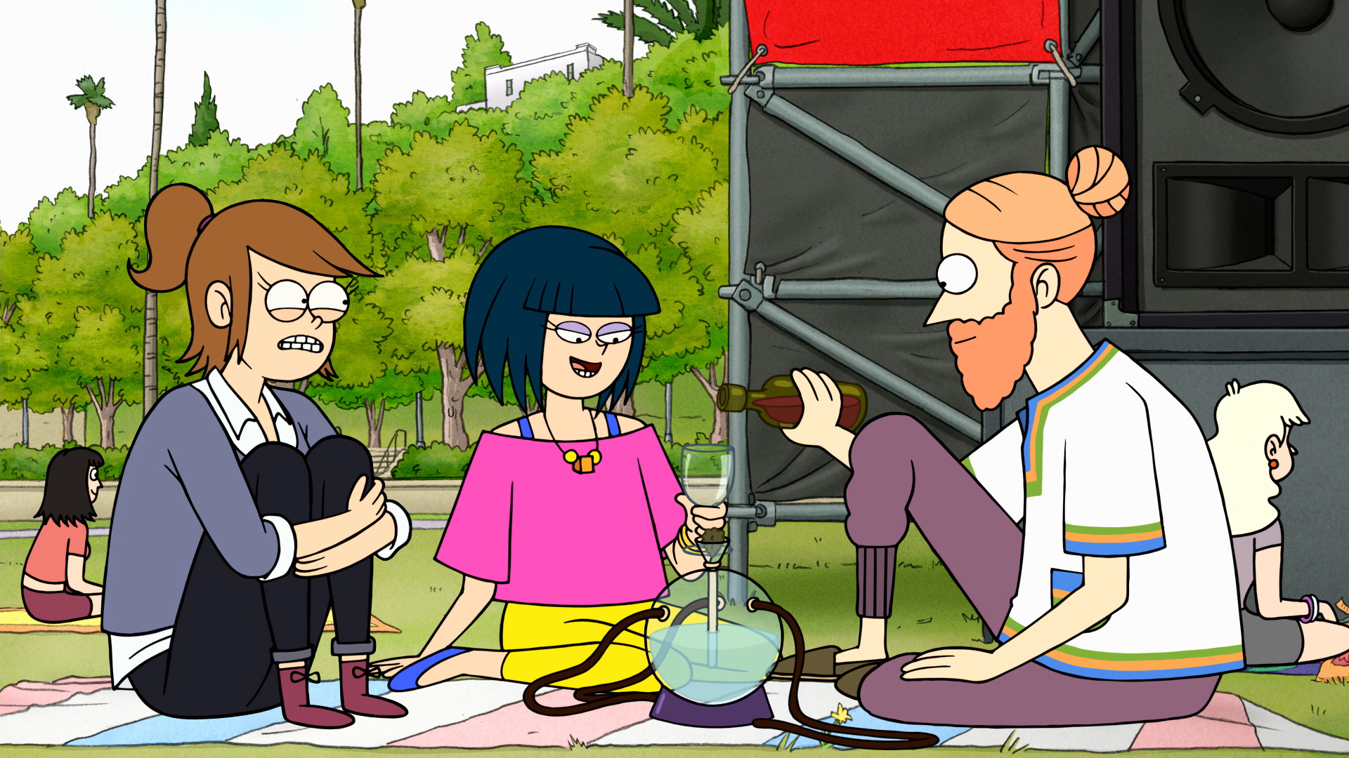 A group of people enjoying a picnic on a blanket in a park.